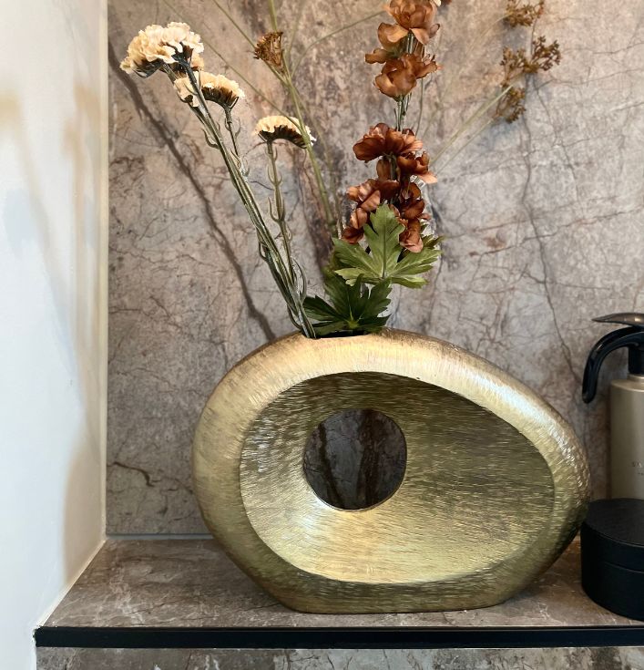 Gouden ovale vaas met gat en kunstbloemen