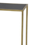 Gouden wandtafel met zwart blad en metalen poten