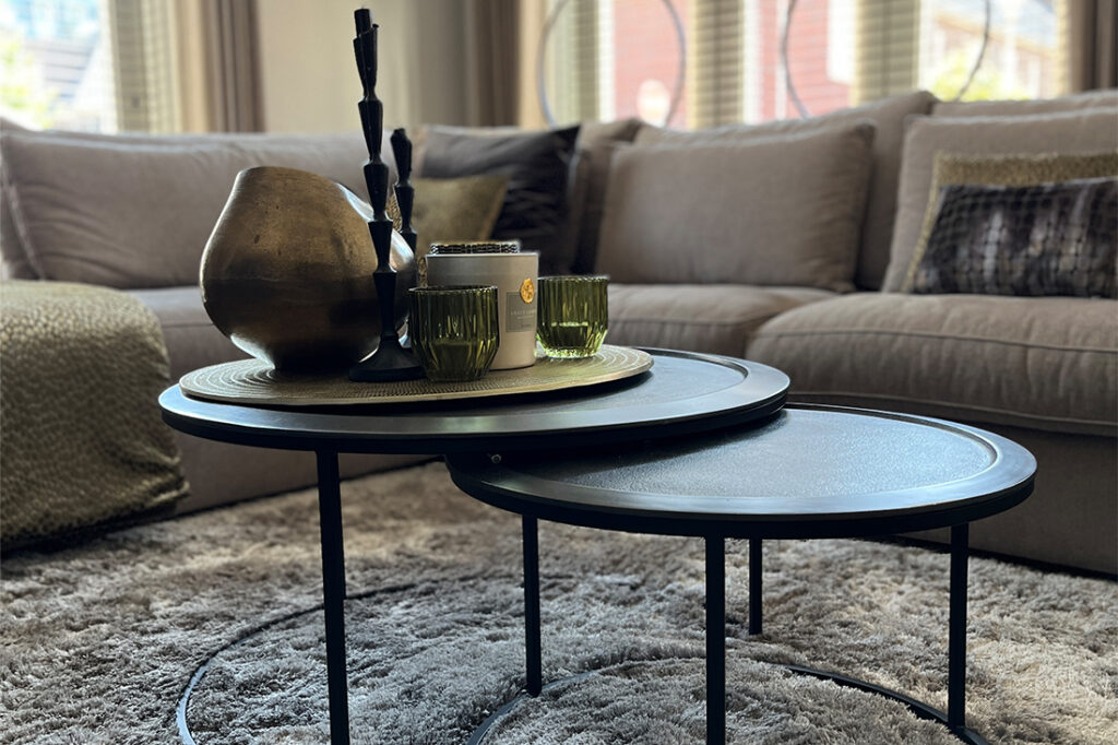 Zwarte ronde salontafelset met rand bronzen vaas en groene theelichtjes