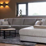 Grijze stoffen hoekbank met liggedeelte